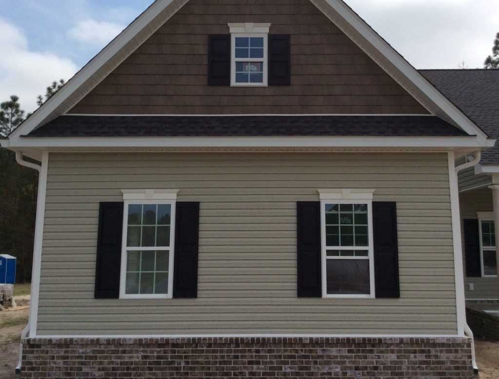 Statesboro Georgia home exterior with vinyl siding and metal roofing in zone 8b climate.