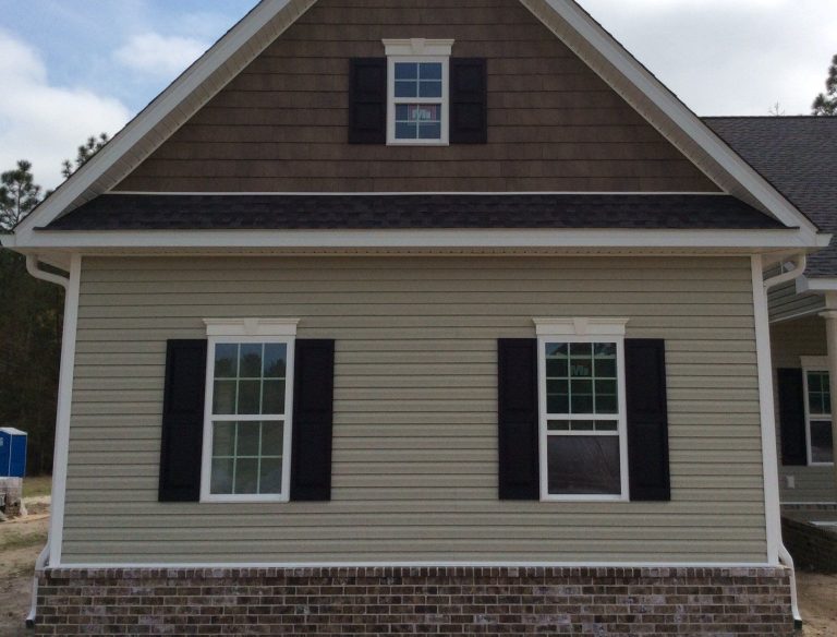 Midway Georgia home exterior showing vinyl siding and metal roofing in high hurricane exposure coastal climate.