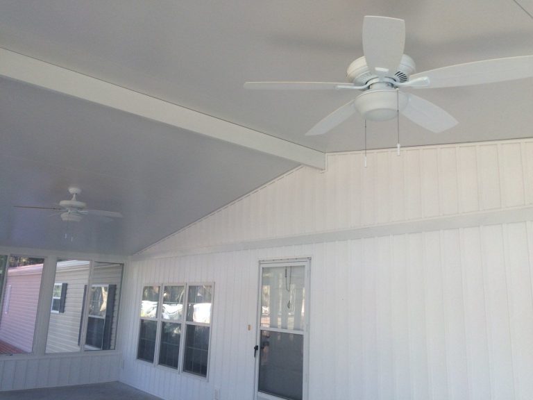Sunroom addition on a Statesboro Georgia home with insulated glass panels and screened walls on a sunny afternoon.