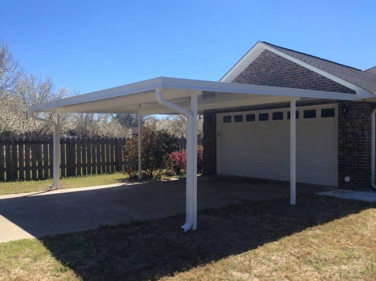 Steel carport protecting vehicle from Claxton's 39-inch annual rainfall and UV exposure.
