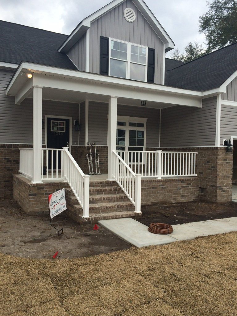 Covered wood porch with decorative columns on a Long County Georgia home near Ludowici.