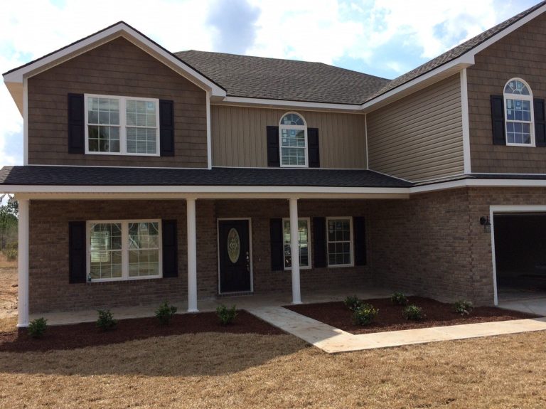 Lap vinyl siding panels installed on an older southeast Georgia home exterior.
