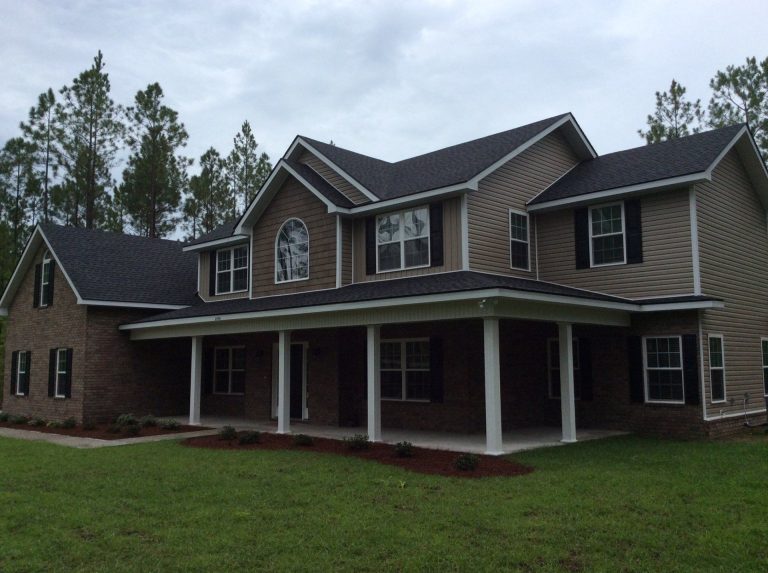 Lap vinyl siding panels on a southeast Georgia home showing Color Through finish in afternoon sun.