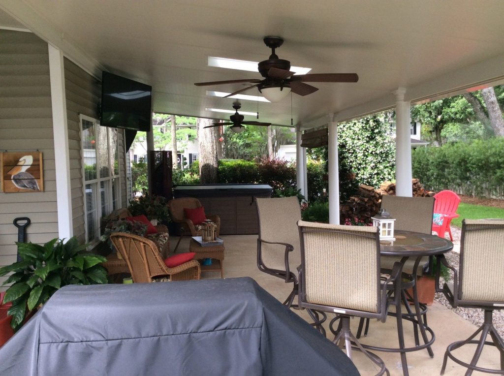 Aluminum patio cover shading a Brunswick Georgia backyard on a hot coastal summer afternoon.