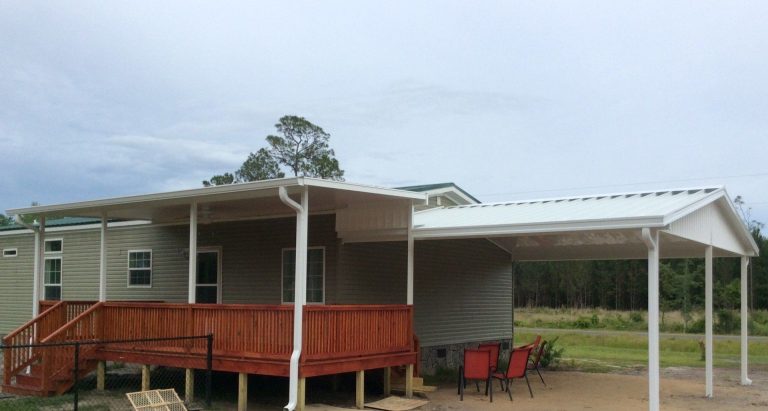Pressure-treated wood deck framing installed for Ludowici Georgia homeowner with termite-resistant post bases.