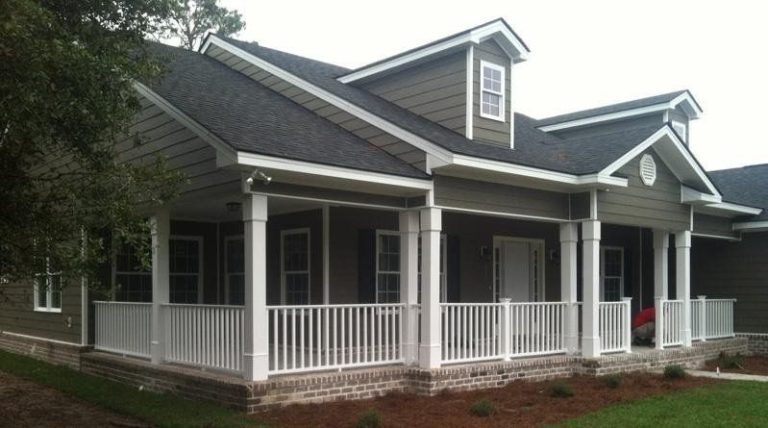 Wood deck stairs and railings on a Toombs County Georgia home with high tree canopy.