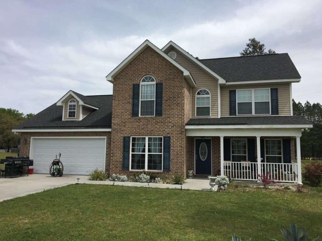 Vinyl lap siding on a Pierce County home built in the 1980s surrounded by southeast Georgia tree canopy.