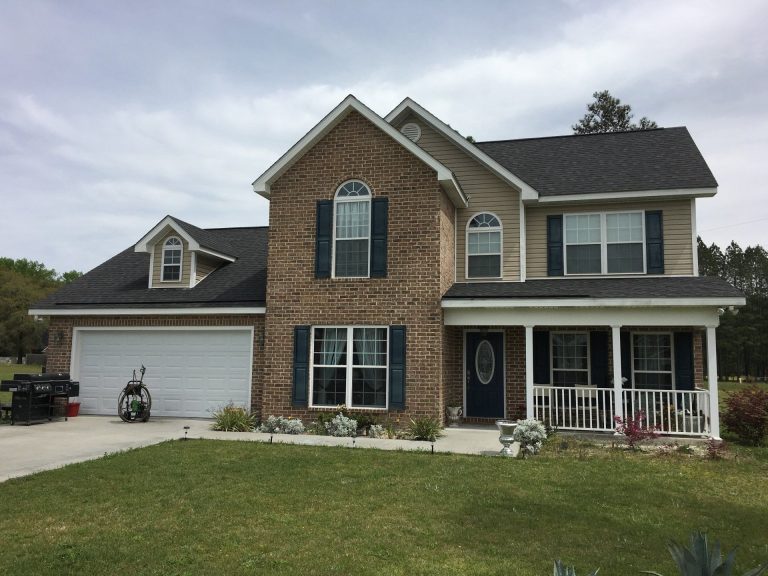 Vinyl lap siding on a Pierce County home built in the 1980s surrounded by southeast Georgia tree canopy.