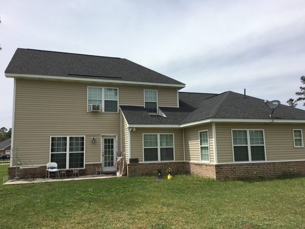 New vinyl lap siding installed on a Blackshear Georgia home with matching white trim and soffit.