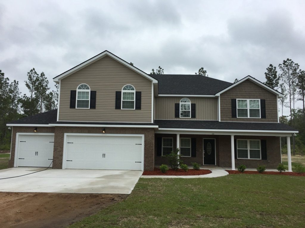Vinyl shake siding on an older Pierce County home replacing faded original wood cladding.