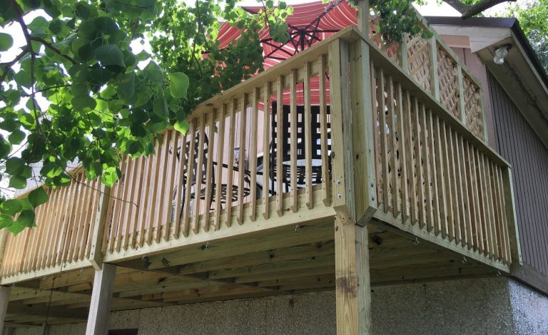 Custom wood porch with decorative columns built in Lyons Georgia by Eicher's Pro Vinyl.