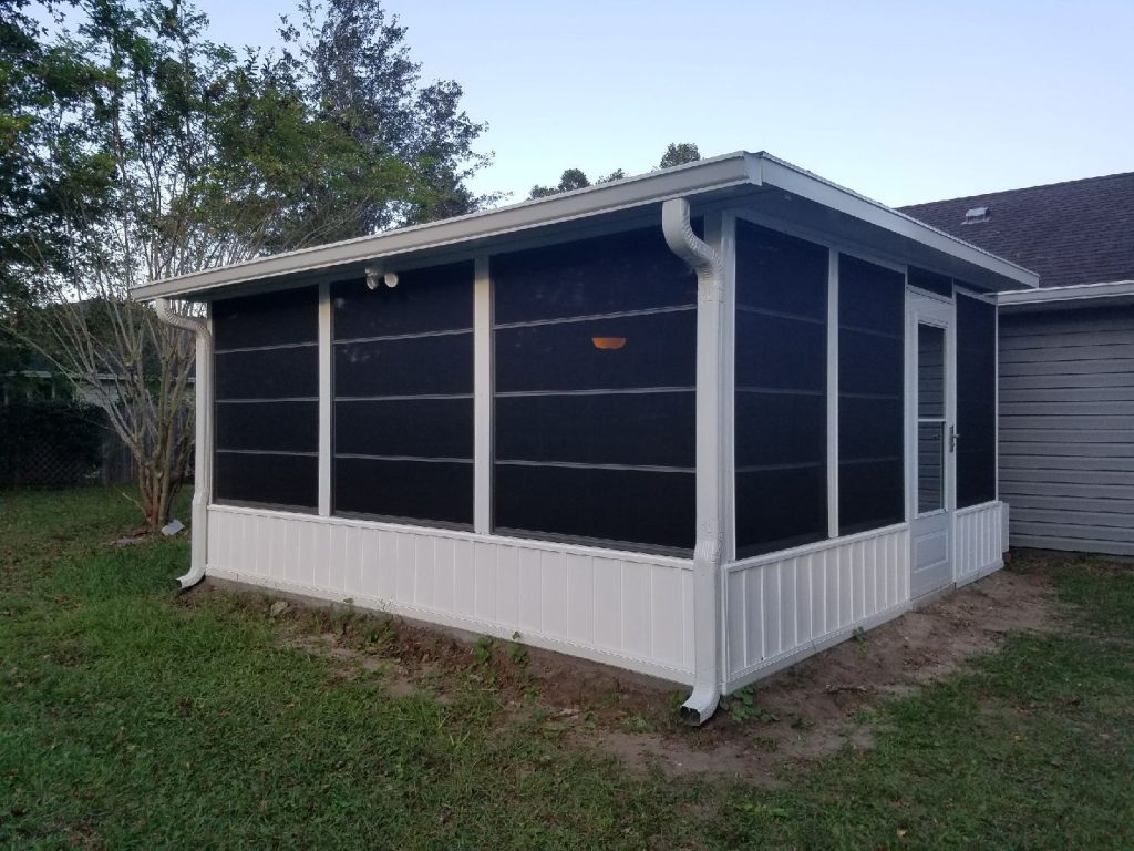 Vinyl Glazed Enclosures in Jesup, GA by Eicher's Pro Vinyl 2 Vinyl glazed track panels installed on a Jesup Georgia porch with Wayne County tree canopy in the background.