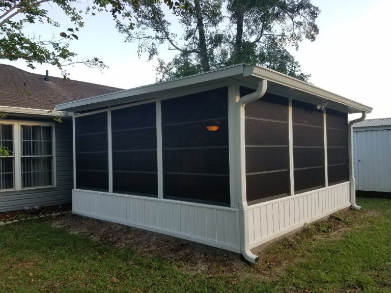Vinyl glazed enclosure on a Waycross Georgia porch shielding homeowners from heavy rain and summer heat.