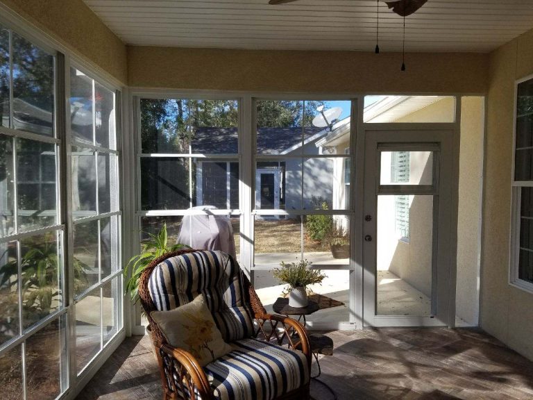 Custom vinyl glazed track window system enclosing a Chatham County deck in Pooler Georgia.