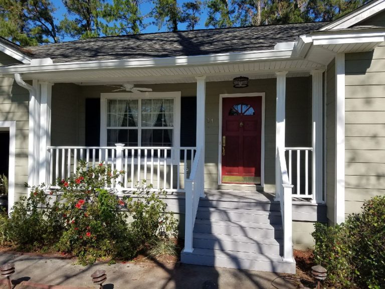 Pressure-treated wood deck with railing installed near Claxton Georgia in Evans County