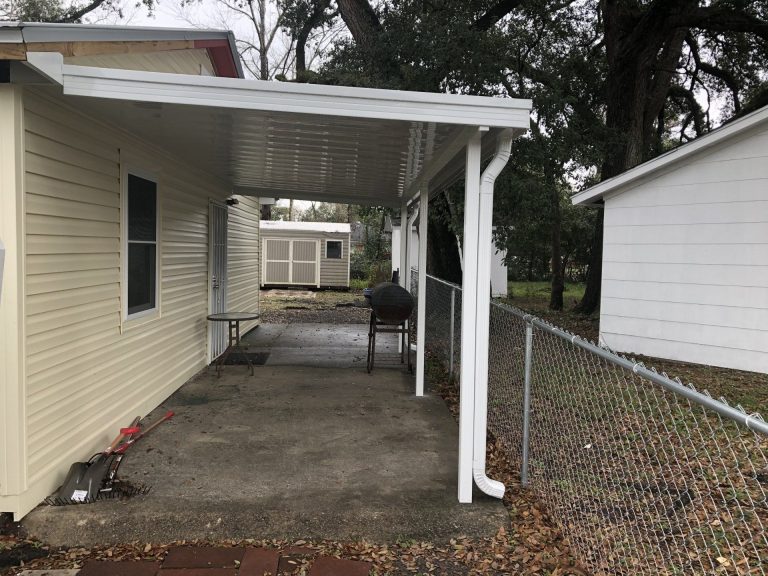 Custom carport on concrete slab protecting truck from southeast Georgia weather