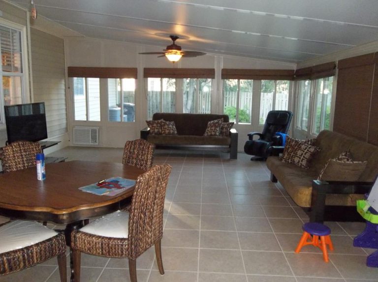 Screened sunroom with gnat-resistant panels on a Claxton Georgia home in high tree canopy area.