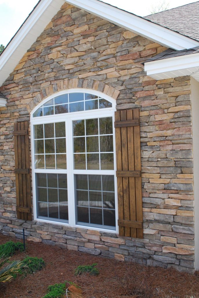 Vinyl siding and metal roofing installation on a Claxton Georgia home in humid coastal climate.
