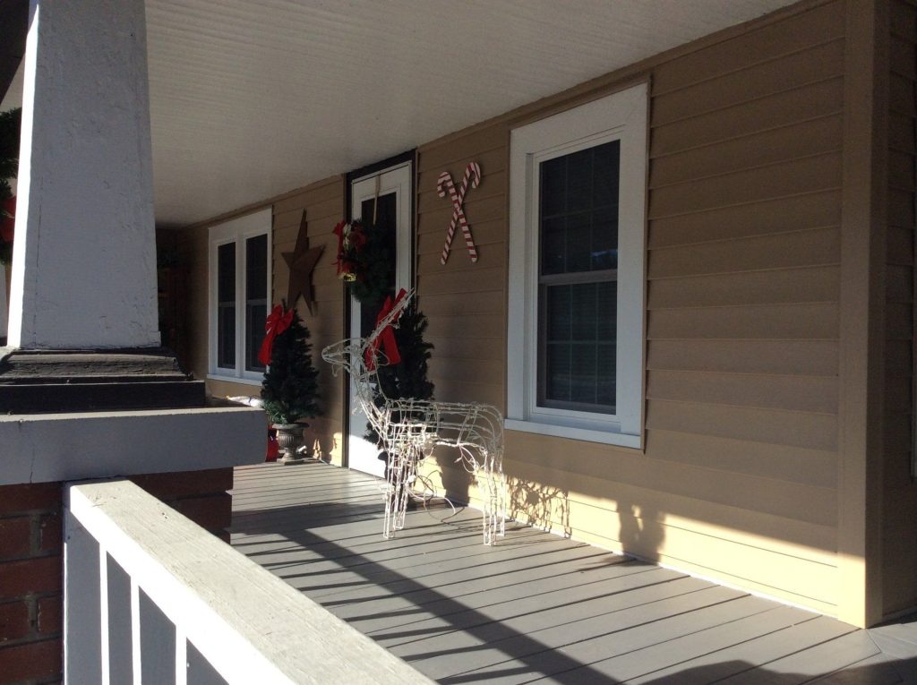 Vinyl siding and metal roofing installation on a Blackshear Georgia home in summer heat.