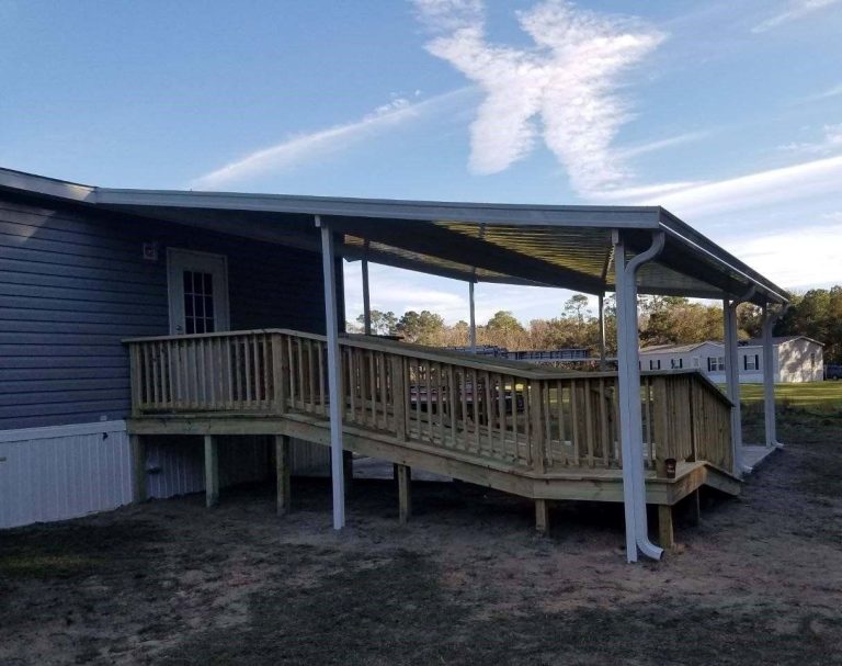 Custom wooden porch built for Blackshear Georgia homeowner surrounded by mature tree canopy shade.