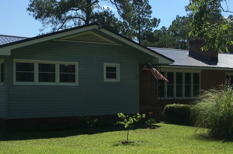 Double-hung vinyl replacement windows with gnat-resistant screens in a Toombs County home.
