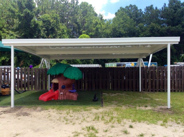 Metal carport protecting vehicles from debris under Reidsville Georgia tree canopy