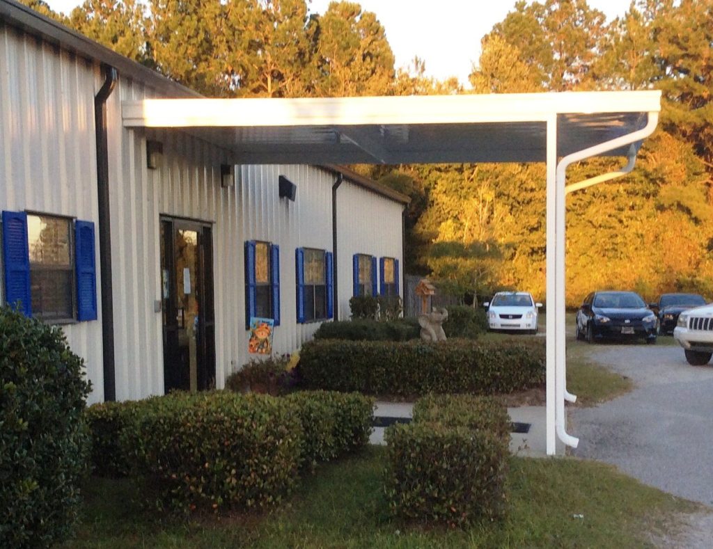 Covered patio structure shading a Hazlehurst Georgia home through a 90-degree summer afternoon
