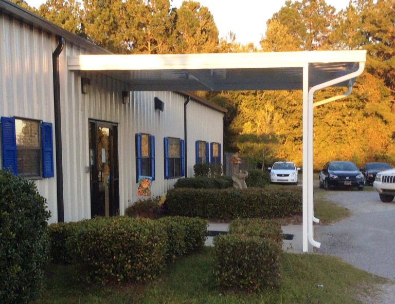 Covered patio structure shading a Hazlehurst Georgia home through a 90-degree summer afternoon