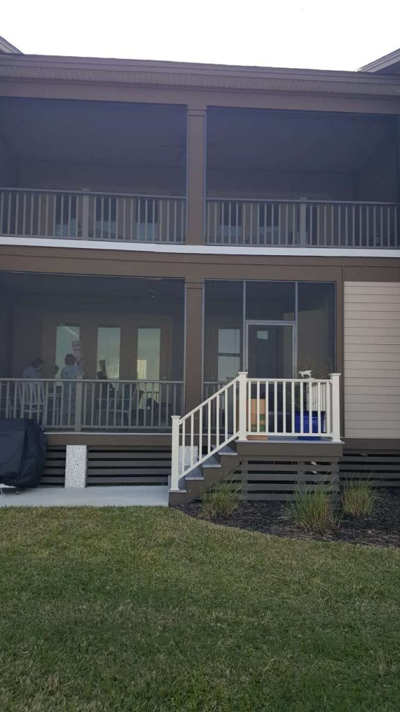 Custom covered wood porch near Waycross Georgia surrounded by southeast Georgia tree canopy