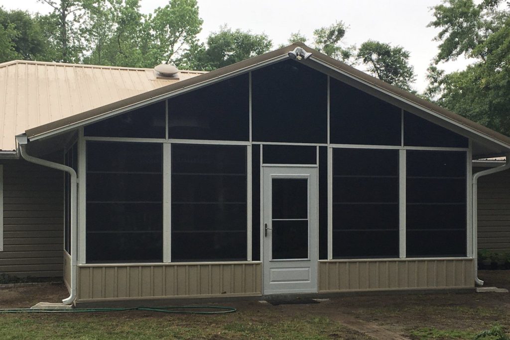 Vinyl glazed porch enclosure on a Hinesville Georgia home during a warm humid summer afternoon.