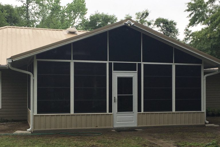 Vinyl glazed porch enclosure on a Hinesville Georgia home during a warm humid summer afternoon.