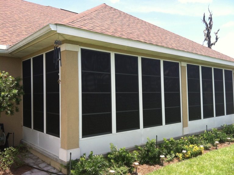 Custom vinyl glazed enclosure installed on a Liberty County home with mature tree canopy.