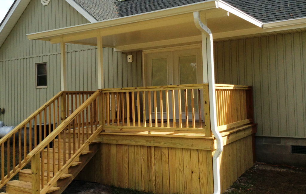 Custom wooden deck built for a Waycross Georgia home under high tree canopy shade