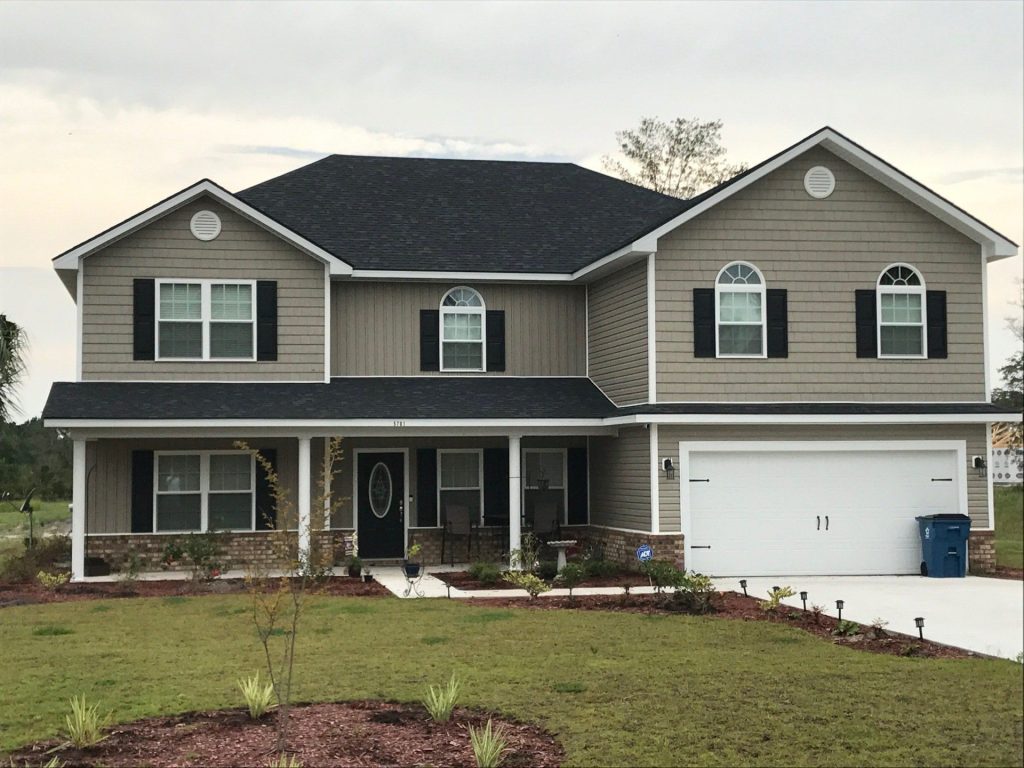 Vinyl siding installation on a Reidsville Georgia home during a hot Tattnall County summer afternoon.