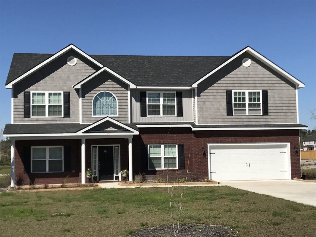 New vinyl siding installed on an Effingham County home during a wet Guyton Georgia summer season.