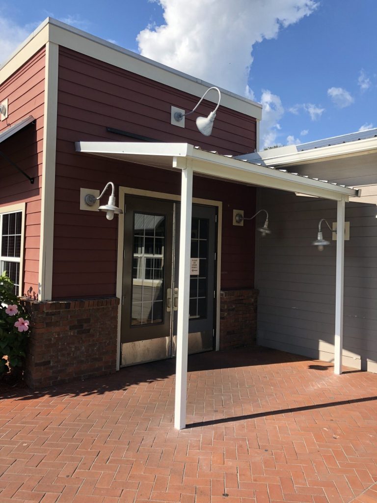 Steel carport shielding a Blackshear Georgia driveway from heavy rain and summer UV exposure