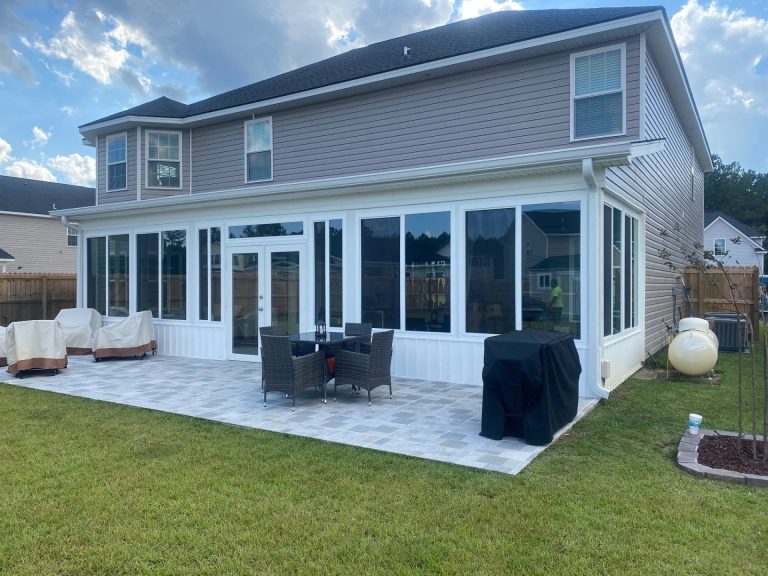 Enclosed four-season sunroom with insulated glazing and vinyl framing on a Lyons Georgia home.