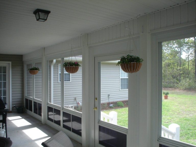 Vinyl glazed porch enclosure with clear sliding panels on an Appling County Georgia home.