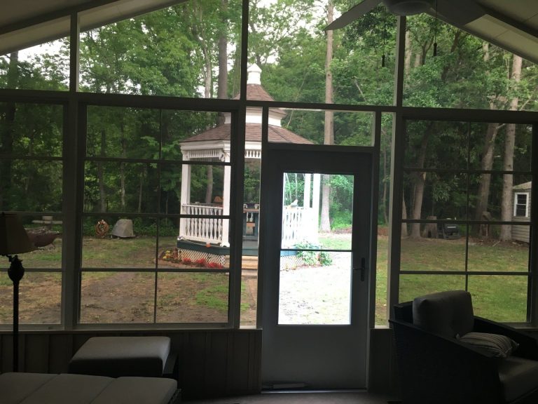Custom 10-mil vinyl glazed sliding panels installed on a screened porch in St. Simons GA.