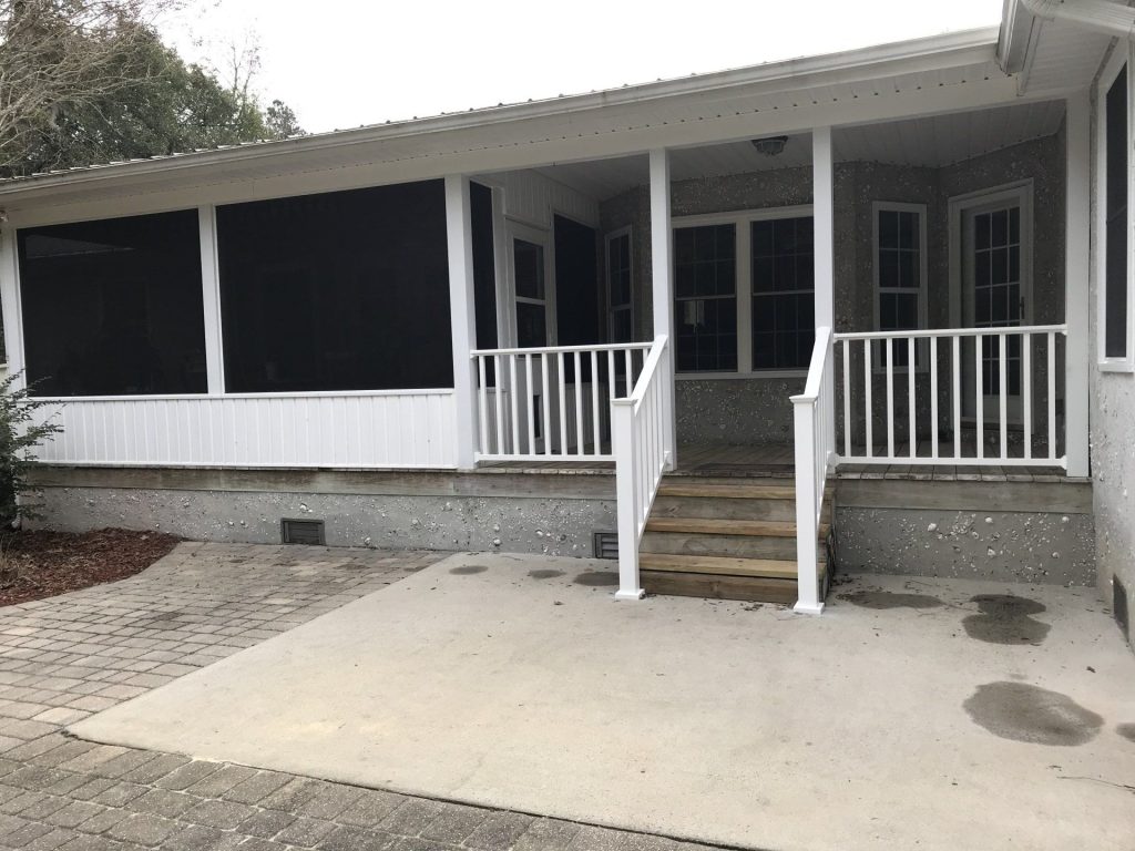 Custom wooden deck with railings built for a Darien homeowner near the Altamaha River in coastal Georgia.