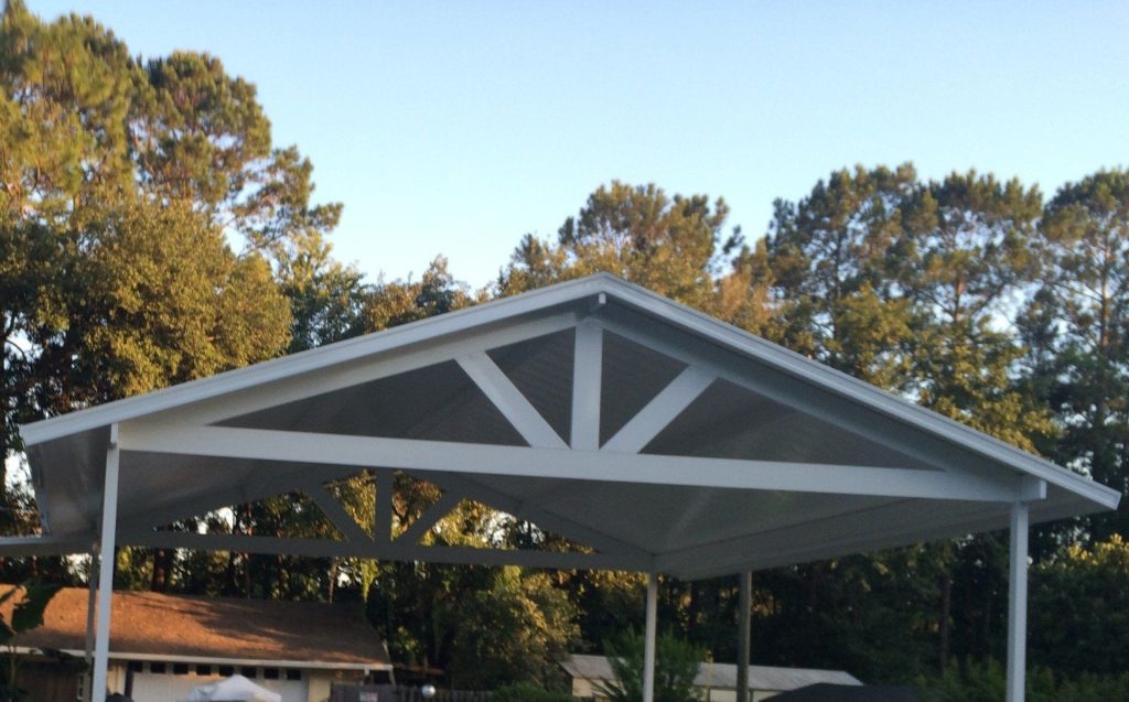 Aluminum carport protecting vehicles at a Ludowici Georgia home from summer heat and rain.
