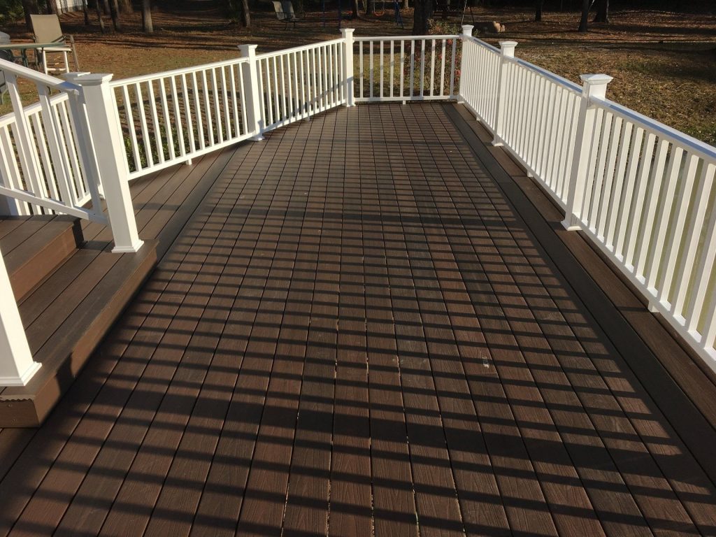 Custom wood porch on a Midway Georgia home with pressure-treated framing and decorative columns.