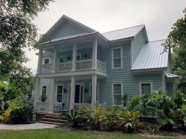 Metal roofing panels installed on a Long County home near Ludowici Georgia with summer storm clouds visible