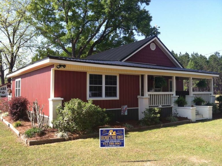 Standing seam metal roof panels on a Ware County home with high tree canopy nearby