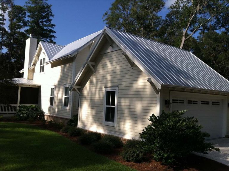 Galvalume steel metal roof installed on a Liberty County home beneath tall Georgia trees.