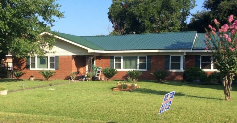 Metal roof installed on St. Marys Georgia home surrounded by high tree canopy in Camden County summer heat.