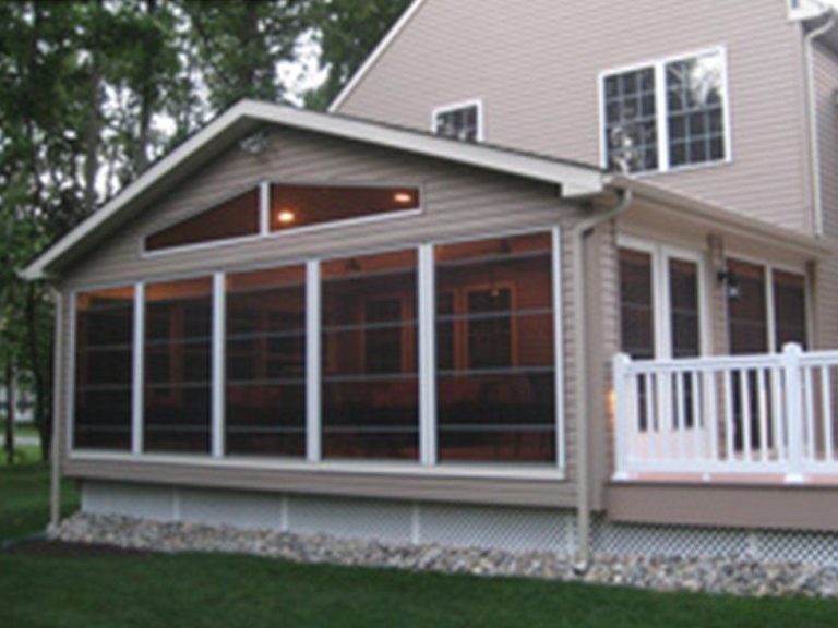 Custom vinyl glazed porch enclosure on a Patterson Georgia home during a hot summer afternoon.