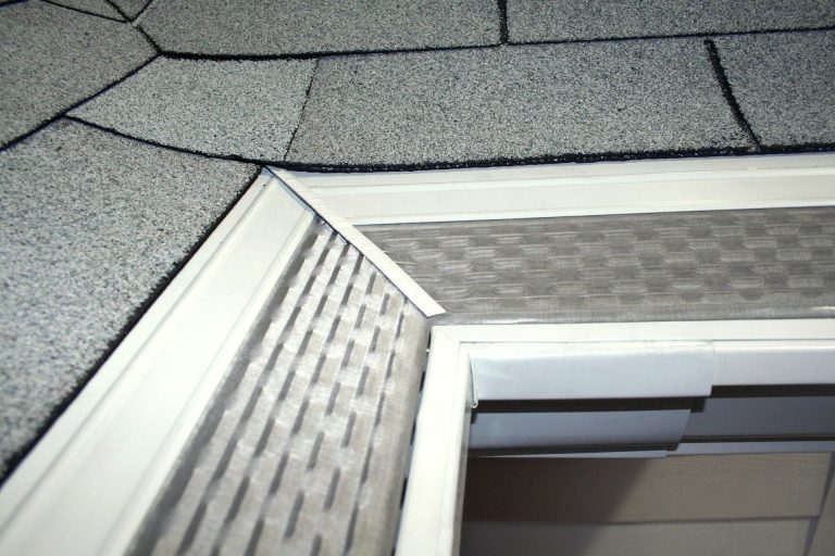 Downspout extension directing rainwater away from a Nahunta home foundation after heavy summer rain.