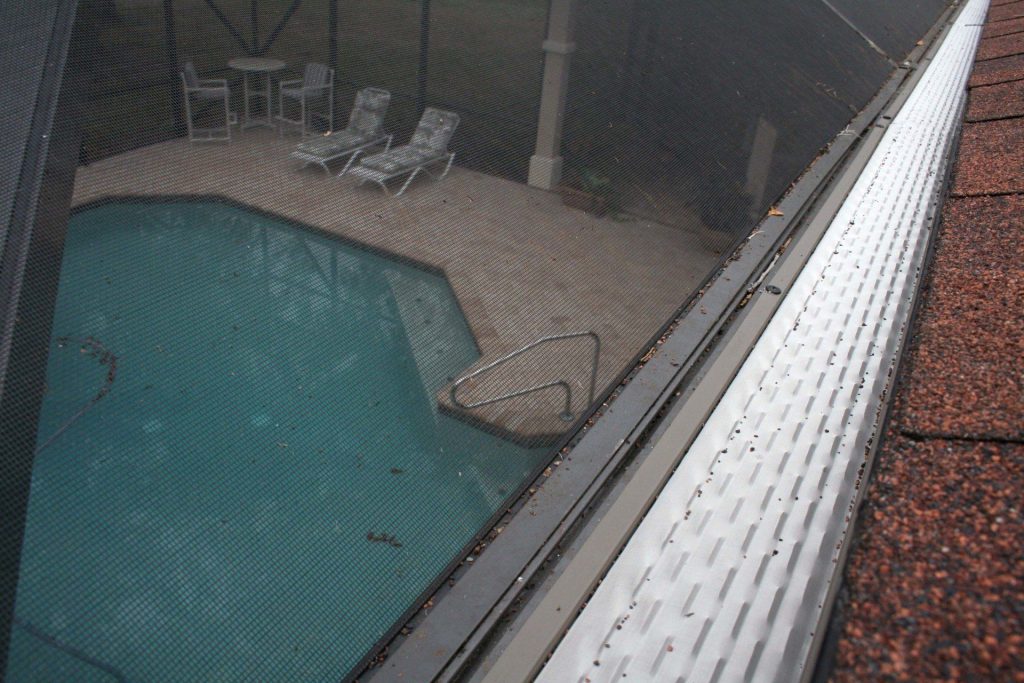 Seamless gutter run draining properly on a Blackshear Georgia home after heavy rainfall.