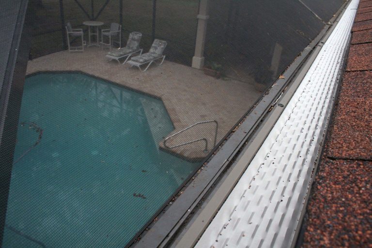 Seamless gutter run draining properly on a Blackshear Georgia home after heavy rainfall.